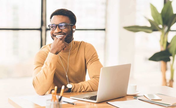 man smiling in his workspace